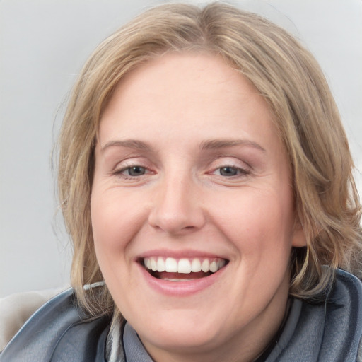 Joyful white young-adult female with medium  brown hair and blue eyes