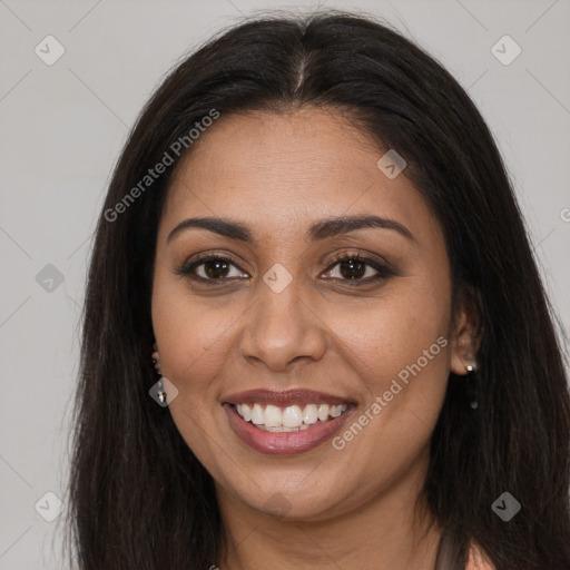 Joyful latino young-adult female with long  brown hair and brown eyes