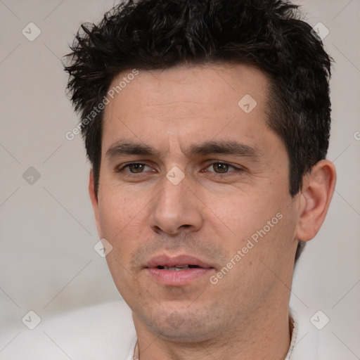 Joyful white young-adult male with short  black hair and brown eyes