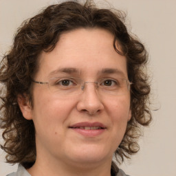 Joyful white adult female with medium  brown hair and brown eyes