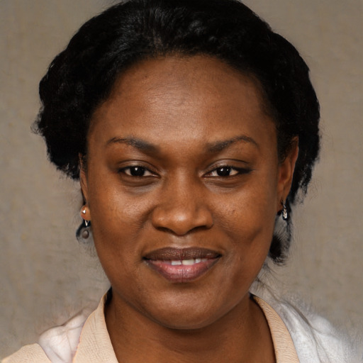 Joyful black adult female with short  black hair and brown eyes