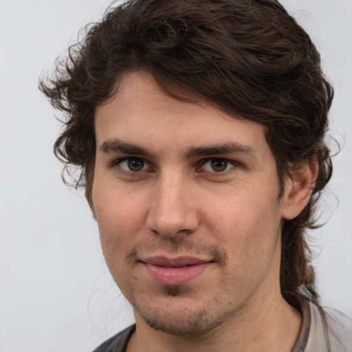 Joyful white young-adult male with medium  brown hair and brown eyes