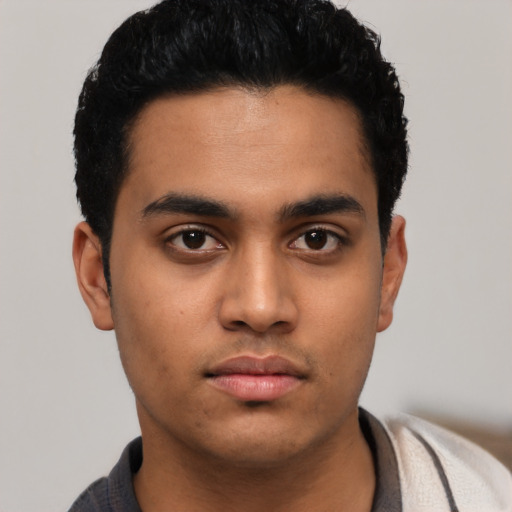 Neutral latino young-adult male with short  black hair and brown eyes