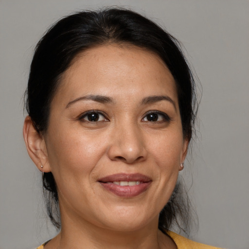 Joyful white adult female with medium  brown hair and brown eyes