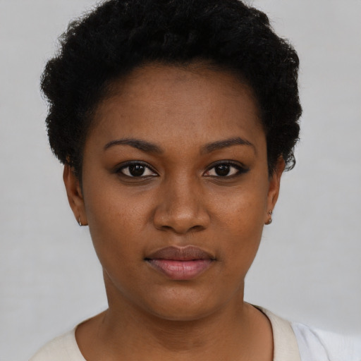 Joyful black young-adult female with short  black hair and brown eyes