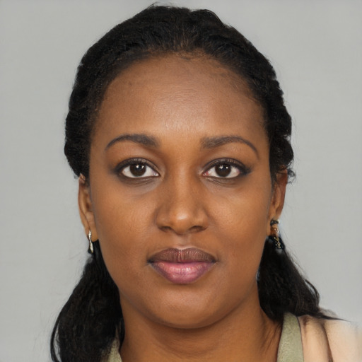 Joyful black young-adult female with long  black hair and brown eyes
