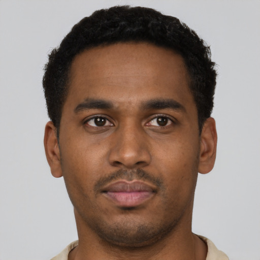 Neutral latino young-adult male with short  brown hair and brown eyes