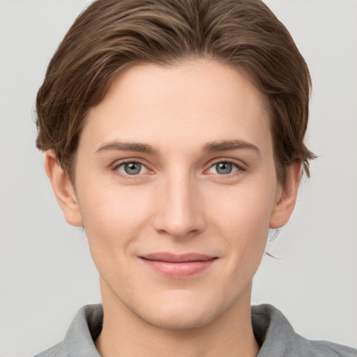 Joyful white young-adult female with short  brown hair and grey eyes