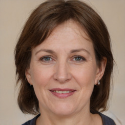 Joyful white adult female with medium  brown hair and brown eyes