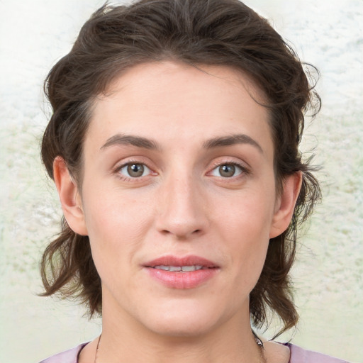 Joyful white young-adult female with medium  brown hair and green eyes