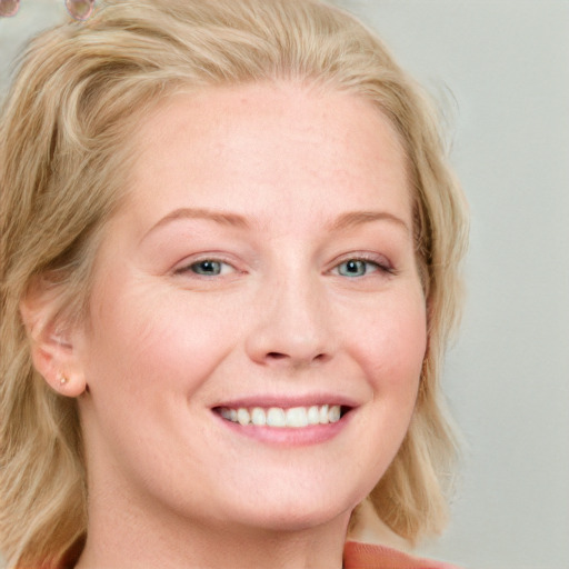 Joyful white young-adult female with long  blond hair and blue eyes