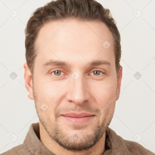 Joyful white young-adult male with short  brown hair and grey eyes