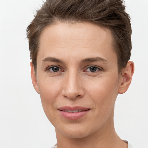 Joyful white young-adult female with short  brown hair and grey eyes