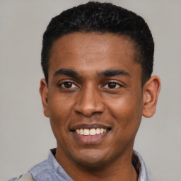 Joyful latino young-adult male with short  black hair and brown eyes