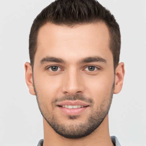 Joyful white young-adult male with short  brown hair and brown eyes