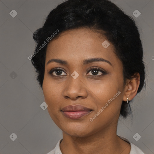 Joyful black young-adult female with medium  black hair and brown eyes