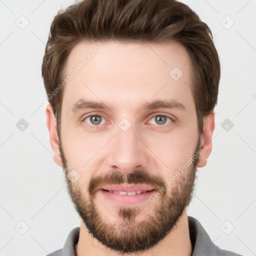 Joyful white young-adult male with short  brown hair and grey eyes