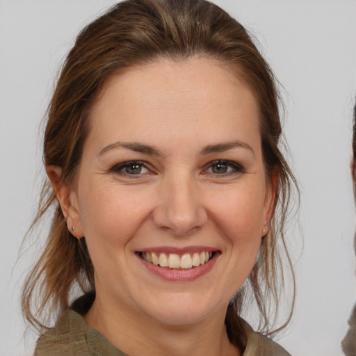 Joyful white young-adult female with medium  brown hair and brown eyes