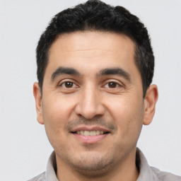 Joyful latino young-adult male with short  black hair and brown eyes
