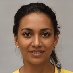 Joyful latino young-adult female with short  brown hair and brown eyes