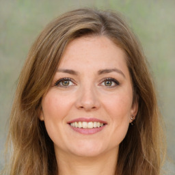 Joyful white young-adult female with long  brown hair and green eyes