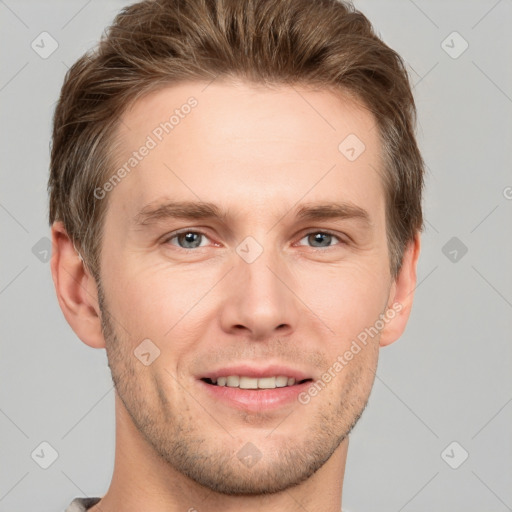 Joyful white young-adult male with short  brown hair and grey eyes