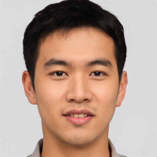 Joyful asian young-adult male with short  brown hair and brown eyes