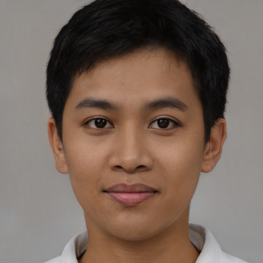 Joyful asian young-adult male with short  black hair and brown eyes
