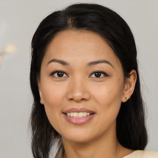 Joyful latino young-adult female with medium  brown hair and brown eyes