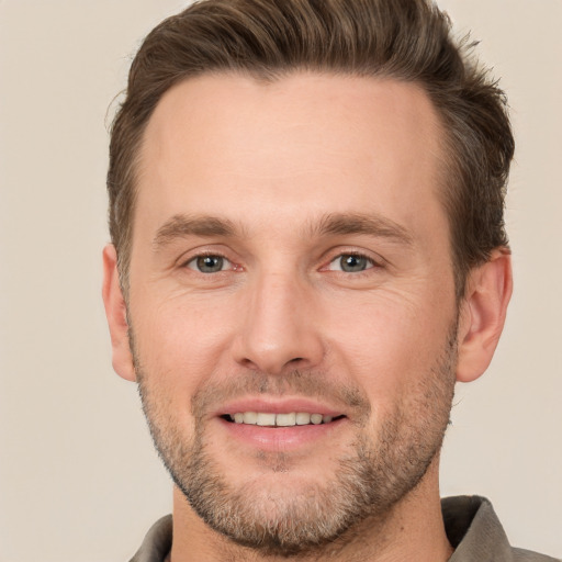 Joyful white adult male with short  brown hair and brown eyes