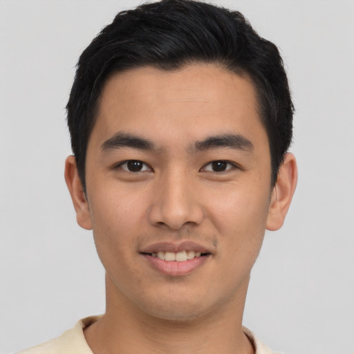 Joyful asian young-adult male with short  black hair and brown eyes