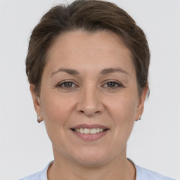 Joyful white adult female with short  brown hair and brown eyes