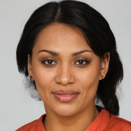 Joyful black young-adult female with medium  black hair and brown eyes