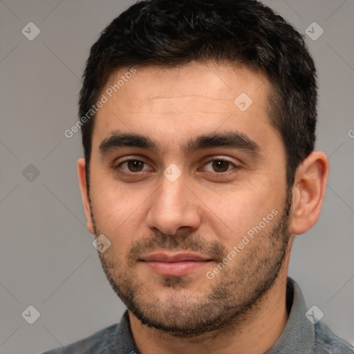 Joyful white young-adult male with short  black hair and brown eyes