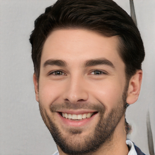 Joyful white young-adult male with short  black hair and brown eyes