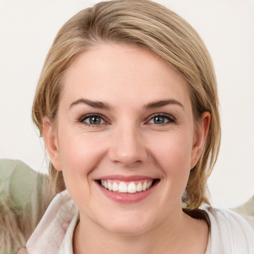 Joyful white young-adult female with medium  brown hair and blue eyes