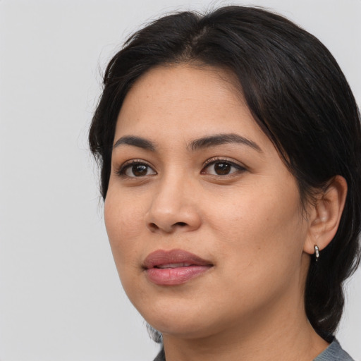 Joyful latino young-adult female with medium  black hair and brown eyes