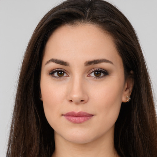 Joyful white young-adult female with long  brown hair and brown eyes