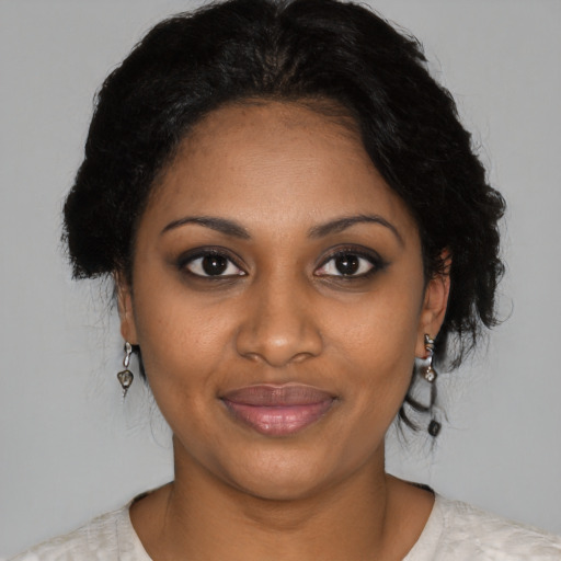 Joyful black young-adult female with medium  brown hair and brown eyes
