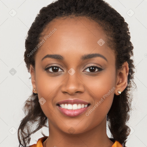 Joyful black young-adult female with long  brown hair and brown eyes