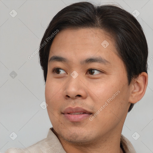 Joyful asian young-adult male with short  brown hair and brown eyes