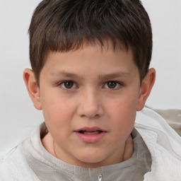 Joyful white child male with short  brown hair and brown eyes