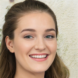 Joyful white young-adult female with long  brown hair and green eyes