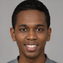 Joyful black young-adult male with short  black hair and brown eyes