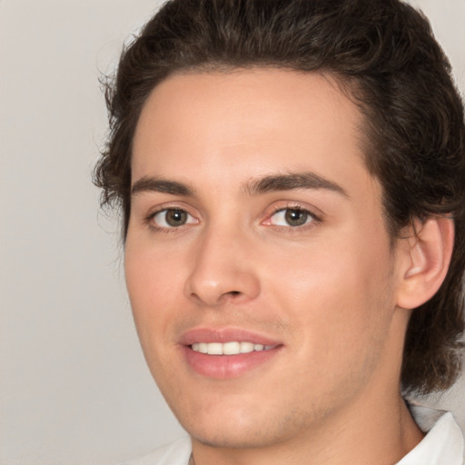 Joyful white young-adult male with medium  brown hair and brown eyes