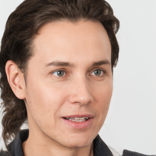 Joyful white young-adult male with medium  brown hair and brown eyes