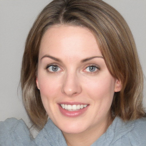 Joyful white young-adult female with medium  brown hair and blue eyes