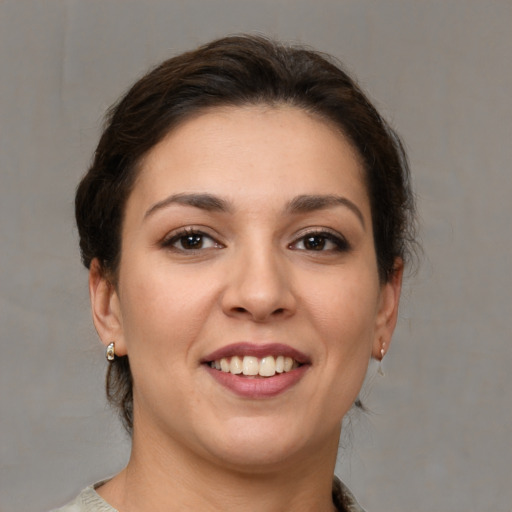 Joyful white young-adult female with medium  brown hair and brown eyes