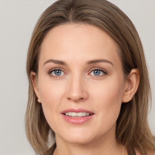 Joyful white young-adult female with long  brown hair and grey eyes