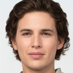 Joyful white young-adult male with medium  brown hair and grey eyes